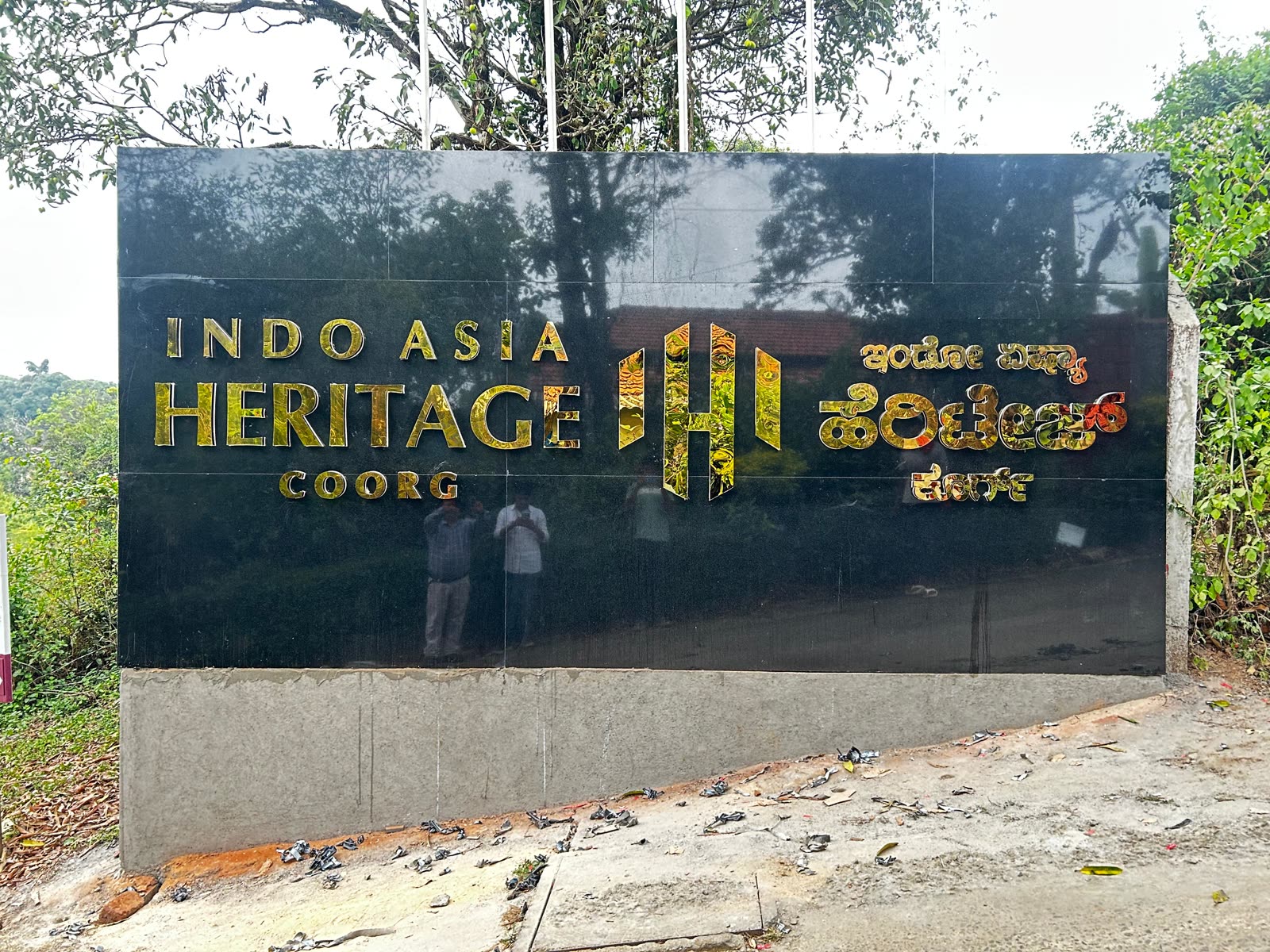 Indo Asia Heritage Coorg in gold letters, Kannada and English, on a black granite wall