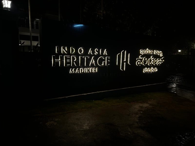 Indo Asia Heritage Madikeri letters back-lit at night