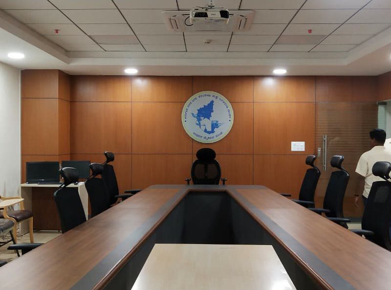 Conference room with the round emblem mounted on a wood-panelled wall