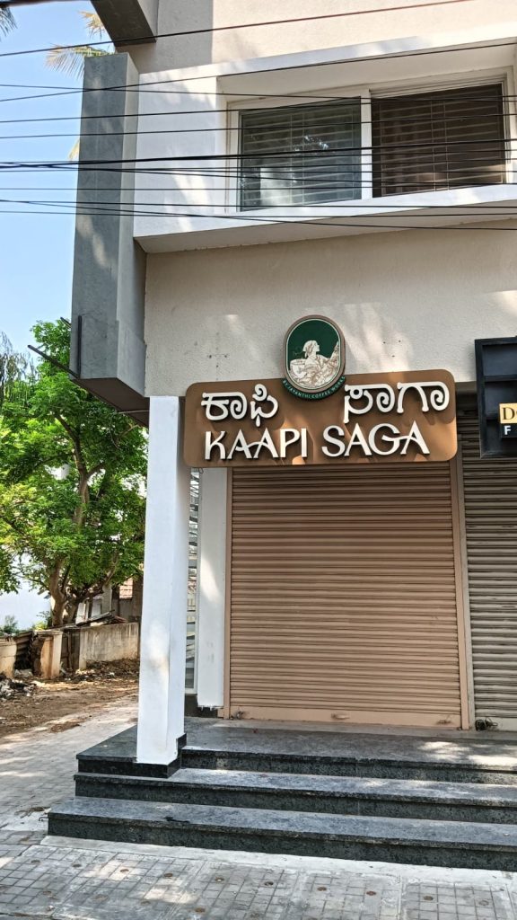 Kaapi Saga cafe fascia with raised letters in Kannada and English