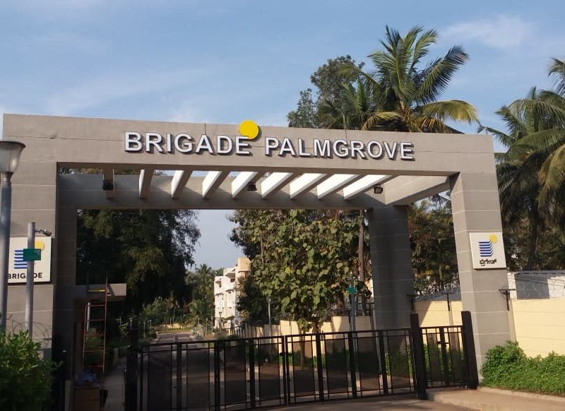 Brigade Palmgrove entrance gate seen from the approach road, with the project plan board beside it