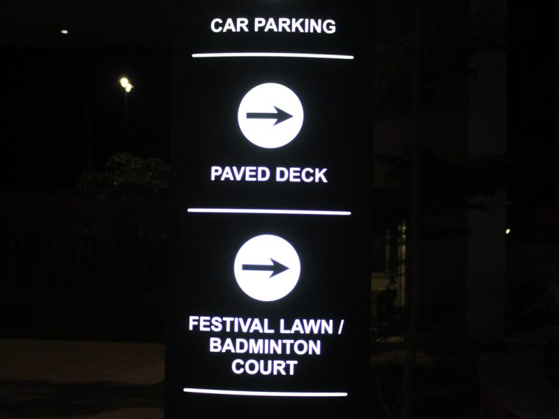 Lit direction totem with arrows to Car Parking, Paved Deck and Festival Lawn