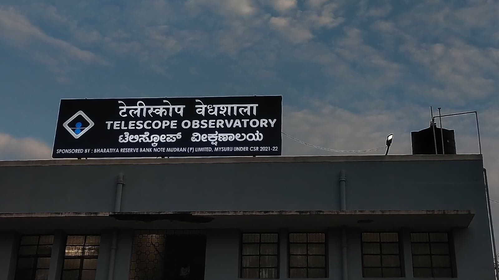 Telescope Observatory board on the roof of a building, by day